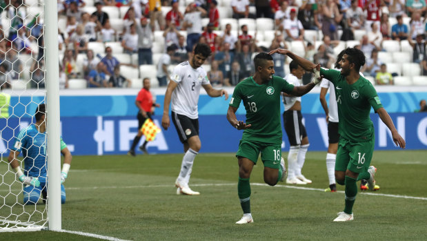 Saudi Arabia's Salem Aldawsari, centre, celebrates scoring the winner.