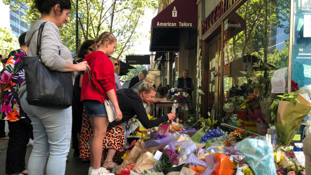 Members of the public pay their respects.