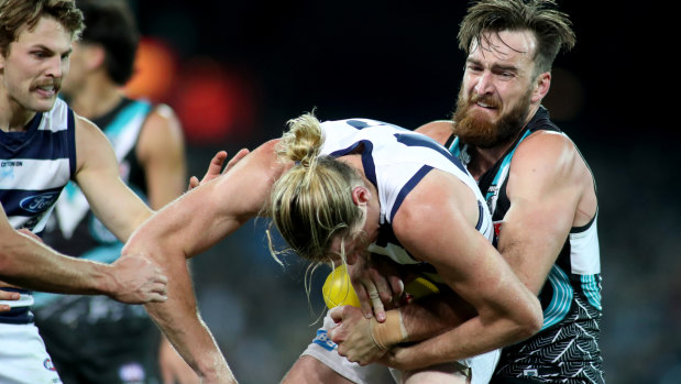Port Adelaide's Charlie Dixon tackles Geelong's Mark Blicavs at Adelaide Oval.
