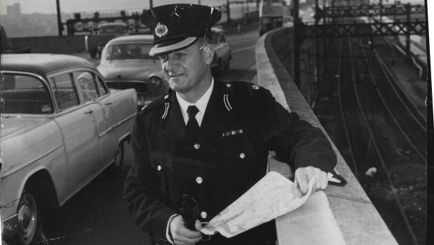 The Police Traffic Chief, Superintendent M. W. Chaseling, watches the flow of traffic over the Harbour Bridge  as the North side change-over from trams to buses received its first main test. July 1, 1958. 