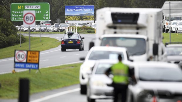 Vehicles arriving from New South Wales queuing to cross the Queensland border at Coolangatta on Monday.