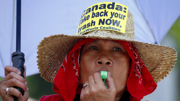A woman blows her whistle during a protest outside the Canadian Embassy last week. 