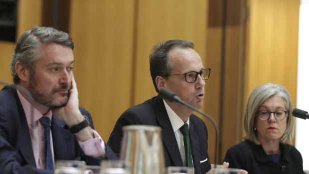 Daniel Crennan, James Shipton and Karen Chester from the Australian Securities and Investments Commission (ASIC) during a hearing with the Standing Committee on Economics at Parliament House in Canberra 