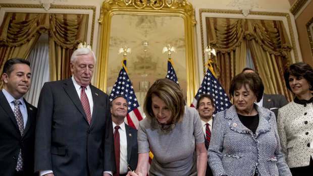 House Speaker Nancy Pelosi signs a deal to reopen the government.