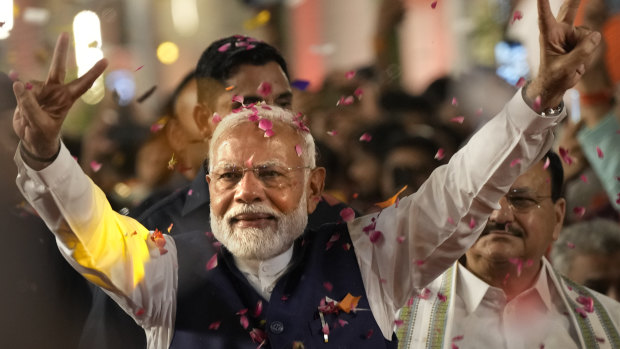 Prime Minister Narendra Modi greets supporters as he arrives at Bharatiya Janata Party headquarters in New Delhi on Tuesday.