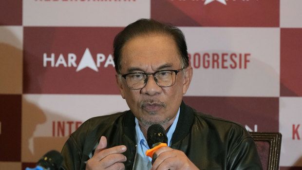Opposition leader Anwar Ibrahim fronts a news conference early on Sunday.