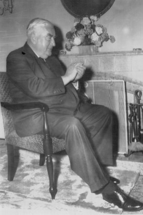 The Prime Minister, Sir Robert Menzies, jokingly applauding himself while watching his own policy speech on television. 