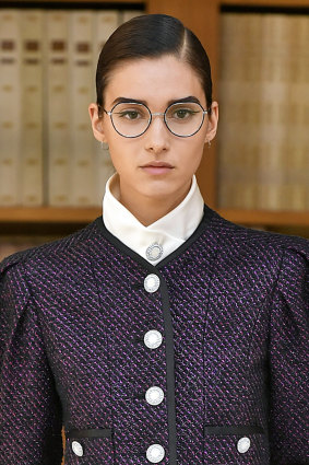 Model Rachelle Harris wearing winged eyeliner and lashes under glasses at the Chanel Paris Haute Couture Week show in July.