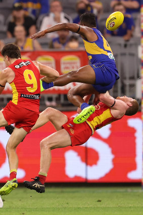 West Coast’s Willie Rioli collides with Gold Coast young gun Matt Rowell.