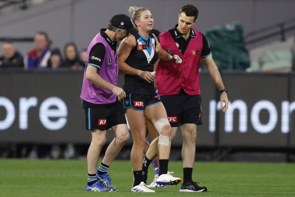 Port Adelaide’s Janelle Cuthbertson is helped off the ground after rupturing her ACL.