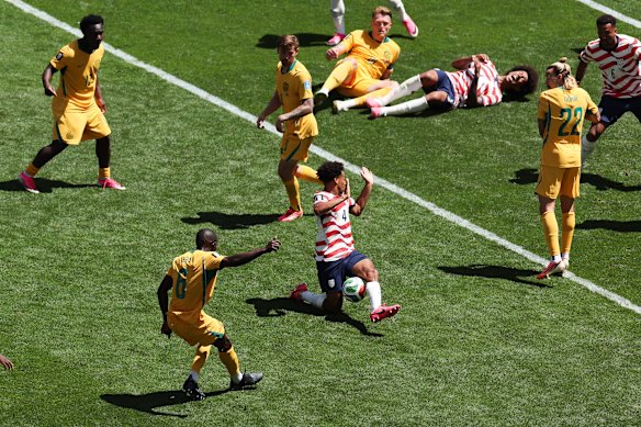 United States’ Tyler Adams (4) blocks a shot by Australia’s Jason Geria.