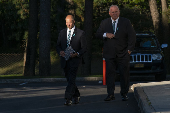 Gabby Petito’s stepfather Jim Schmidt, left, exits Moloney’s Funeral Home.