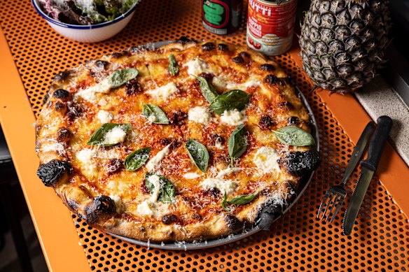 Jupiter pizza with tomato, mozzarella, ’nduja, stracciatella, basil, hot honey and pecorino.