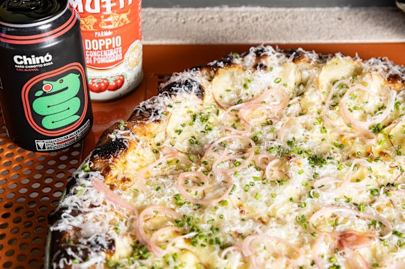 Light & Tangy pizza with a sour cream base showered with snipped chives and pickled red onion, plus mozzarella and finely sliced potato.