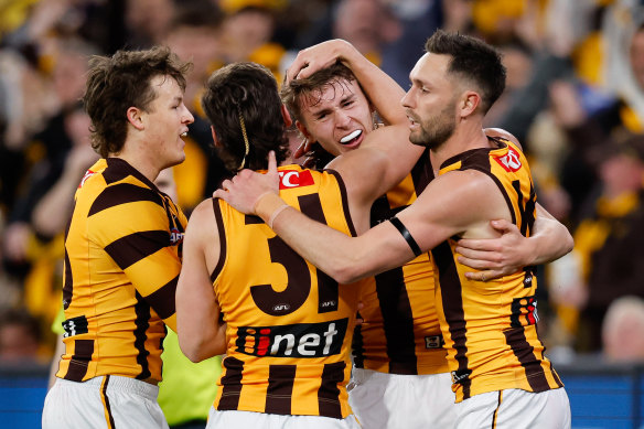 Calsher Dear of the Hawks celebrates a goal with teammates.