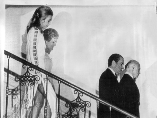 Mrs McMahon and Mrs Nixon follow their husbands downstairs at the White House.