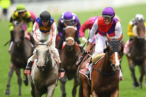 Jockey Damien Oliver celebrates winning the 2019 Victoria Derby, which this year faces a potential clash with AFL finals. 