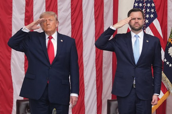 US President Donald Trump, left, and Vice President JD Vance salute at Arlington National Cemetery on Monday.