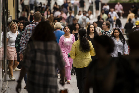 Shoppers pack Queen Street Mall.