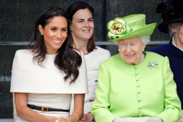 Meghan, Duchess of Sussex, and the Queen with Australian Samantha Cohen behind them.