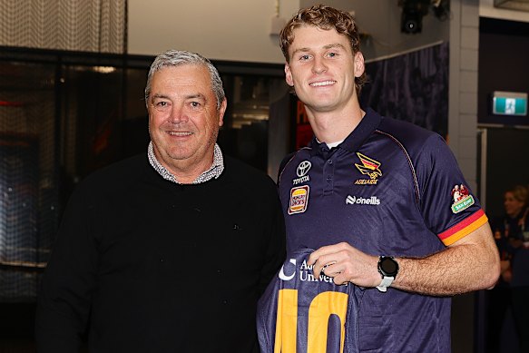 Adelaide debutant Hugo Hall-Kahan being presented his jumper by Bruce Linder.