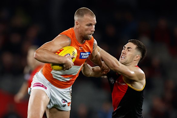 Jake Stringer of the Giants fends off Jade Gresham of the Bombers.