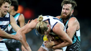 Port Adelaide's Charlie Dixon tackles Geelong's Mark Blicavs at Adelaide Oval.