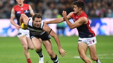 Geelong's Patrick Dangerfield breaks free of Melbourne's Alex Neal-Bullen.