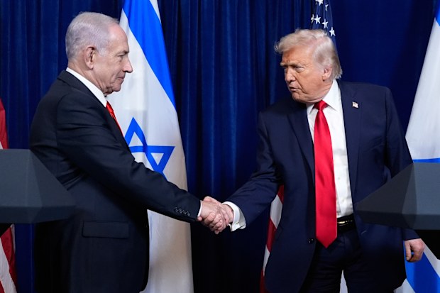 Trump shakes hands with Israeli Prime Minister Benjamin Netanyahu at a news conference in Mar-a-Lago in December.