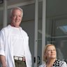 Andrew and Lisa Cook on their balcony, which is still undergoing repairs.