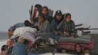 A displaced Palestinian family on a truck loaded with belongings as they travel along the coastal road near Wadi Gaza.
