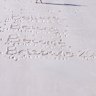 The Brisbane 2032 slogan written in the sand in Queensland’s Whitsunday Islands.