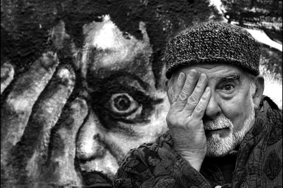 Lloyd Jones entering his fourth decade at La Mama. He directed over 40 productions at the theatre and several works to mark the milestone. He is in front of a painting by Paula Levis based on Michelangelo’s The Last Judgement, to publicise his work, Discontinuities.