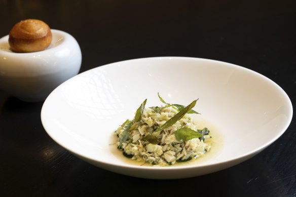 The mud crab dish is prepared tableside, mixed with smoked bonito consomme and aromatics.