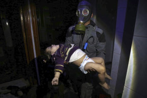 A rescue worker carries a child following an alleged chemical weapons attack in the rebel-held town of Douma, near Damascus, on Saturday night.