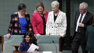 Ms Banks, who made her speech to a near-empty House of Representatives, was later surrounded by other crossbenchers.
