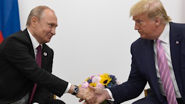 Russian President Vladimir Putin shakes hands with US President Donald Trump in 2019.