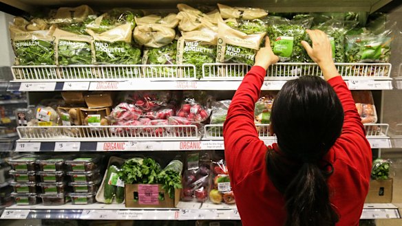 Workers re-stock shelves at Coles.