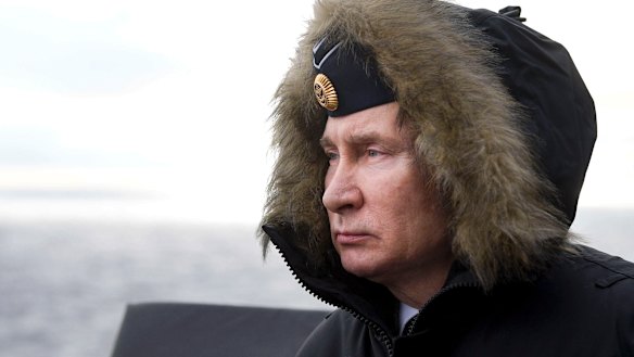 Russian President Vladimir Putin watches a navy exercise from the Marshal Ustinov missile cruiser in the Black Sea, Crimea, in January.