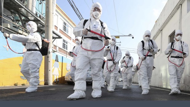 Soldiers spray disinfectant as a precaution against the coronavirus in Gyeongsan, South Korea.