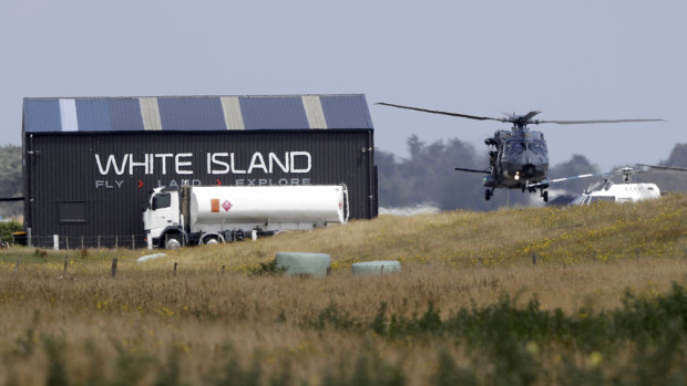 A navy helicopter returns to Whakatane Airport following the recovery operation to retrieve victims.