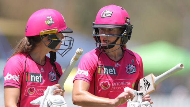 Erin Burns (left) talks to Sixers teammate Ellyse Perry during a WBBL clash in January.