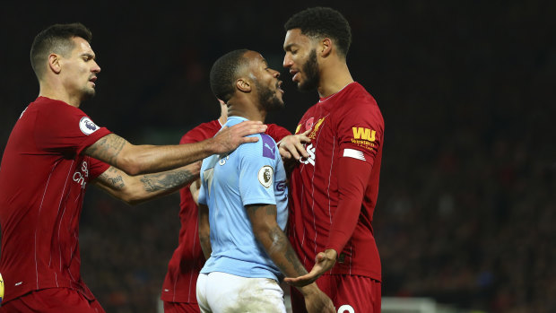Raheem Sterling and Joe Gomez come together during Liverpool's victory over City on Sunday.