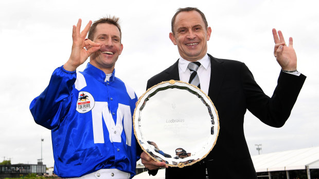 Awesome foursome: Hugh Bowman and Chris Waller celebrate Winx's historic Cox Plate triumph last year.