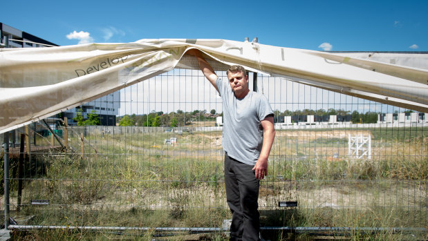 Andrew Bennett at the site of the Tuggeranong apartment building, where he paid a deposit on an apartment almost two years ago, but has now had the deal scrapped against his wishes.