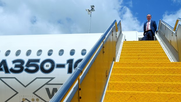 Alan Joyce on the steps of an A350-1000 during a test flight in Sydney in February. 