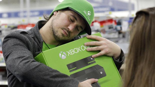 The X factor: a gamer hugs his new Xbox One.