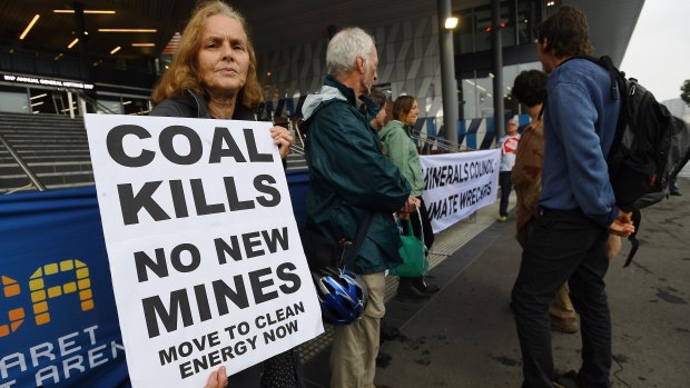 Environment and social justice community groups protest outside BHP's AGM in Melbourne.
