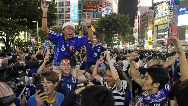 Making history: Fans celebrate in Tokyo's Shibuya shopping district.
