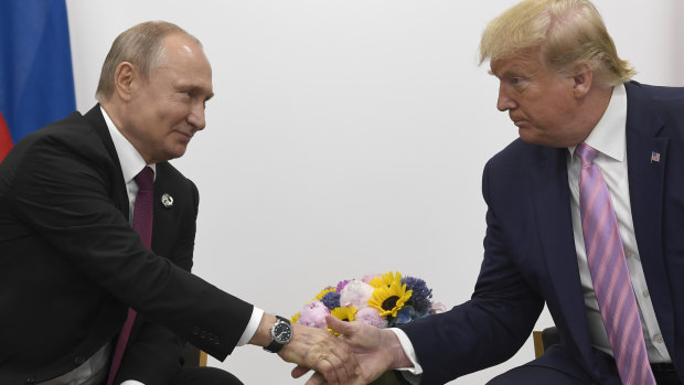 Russian President Vladimir Putin shakes hands with US President Donald Trump in 2019.